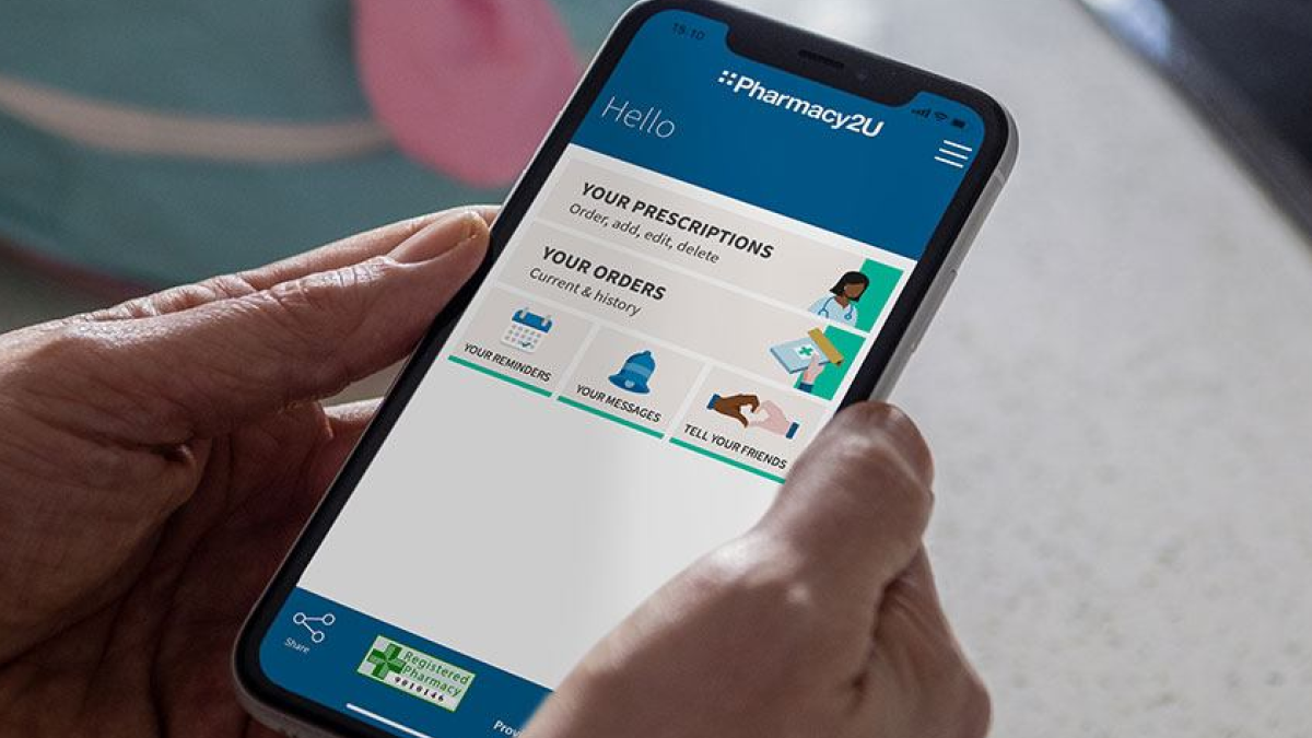 Person holds mobile with Pharmacy2U app open